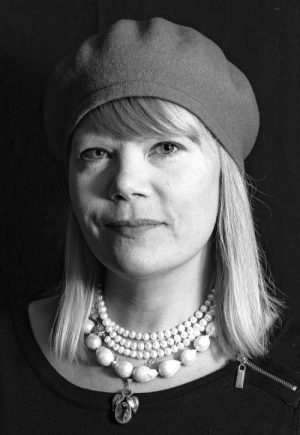 Black-and-white portrait of Ida Haag wearing a beret and a pearl necklace
